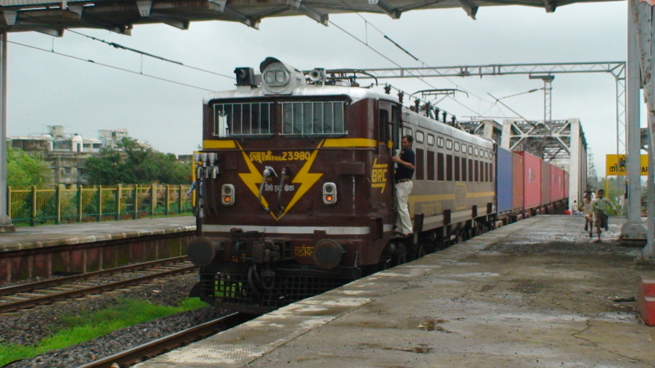 Photo of a freshly painted BRC WAG-5HA 23980 with a Container passing at Kopar Upper station at a slow speed enabling the loco p