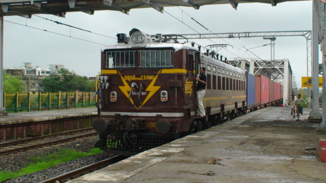 Photo of a freshly painted BRC WAG-5HA 23980 with a Container passing at Kopar Upper station at a slow speed enabling the loco p