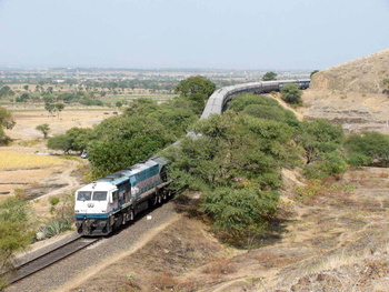 (For Loco Database)
SNAKE IN THE GRASS !

The 1030 Kolhapur Mumbai Cst Koyna Express comes down majestically at the Shindawan