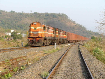 A bcna rake powered by twin KZJ WDG-3A# 14786 provide contrast to the natural background near Chiplun station.  (Arzan Kotval)