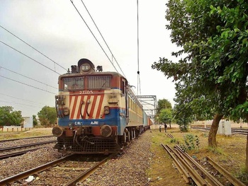 AJNI WAG-7 #27105 Tigerface with container rake at Asaoti in haryana.Shot on a dusty stormy evening of 05-06-2010 by KANWARDEEP 