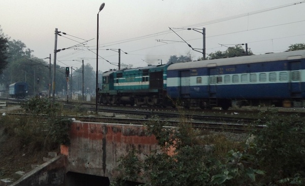 Katni's WDM-2 #16777 departing Lucknow Junction (NER) and moving by the LJN coaching depot with 15010 Chitrakoot Express at its 
