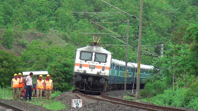 Superb looking LGD WAP-7# 30260 magnificiently coming out of lush greenery with 24 coach long 12723 Hyderabad Decan New Delhi An