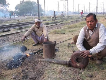 63 Workers Blowing air through a hand driven pump an a section of point.jpg