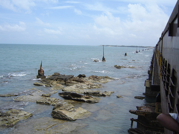 Remnants of the first bridge destroyed by the 1964 cyclone continue to serve as a breakwater for the new bridge