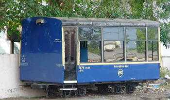 A spanky First Class coach of the Neral Matheran toy train patiently waiting at Neral Junction and having a reflection of the Ka
