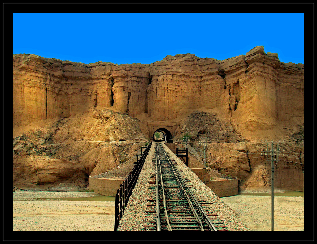 Tunnel entrance through a fortlike hill approachable via a lengthy bridge near Mushkaf station in the Bolan Area of Baluchistan. The tunnel is first of four or more cascaded tunnels & bridges amidst spectecular landscape. Agha Waseem Ahmed.