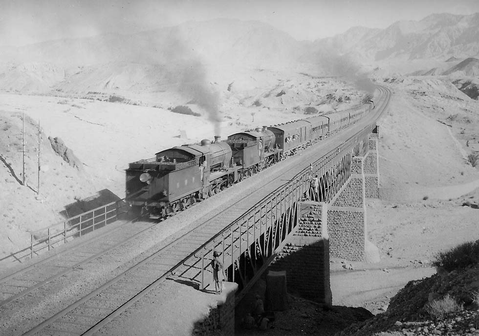 53 Up Lahore - Quetta train of the North Western Railway, hauled by three 2-8-0 type HGS class locomotives, Nannar Nala bridge at the beginning of the Bolan Pass incline. Mid-1930's. (P.S.A. Berridge, from the Soelch collection by permission of Hans Soelch.)